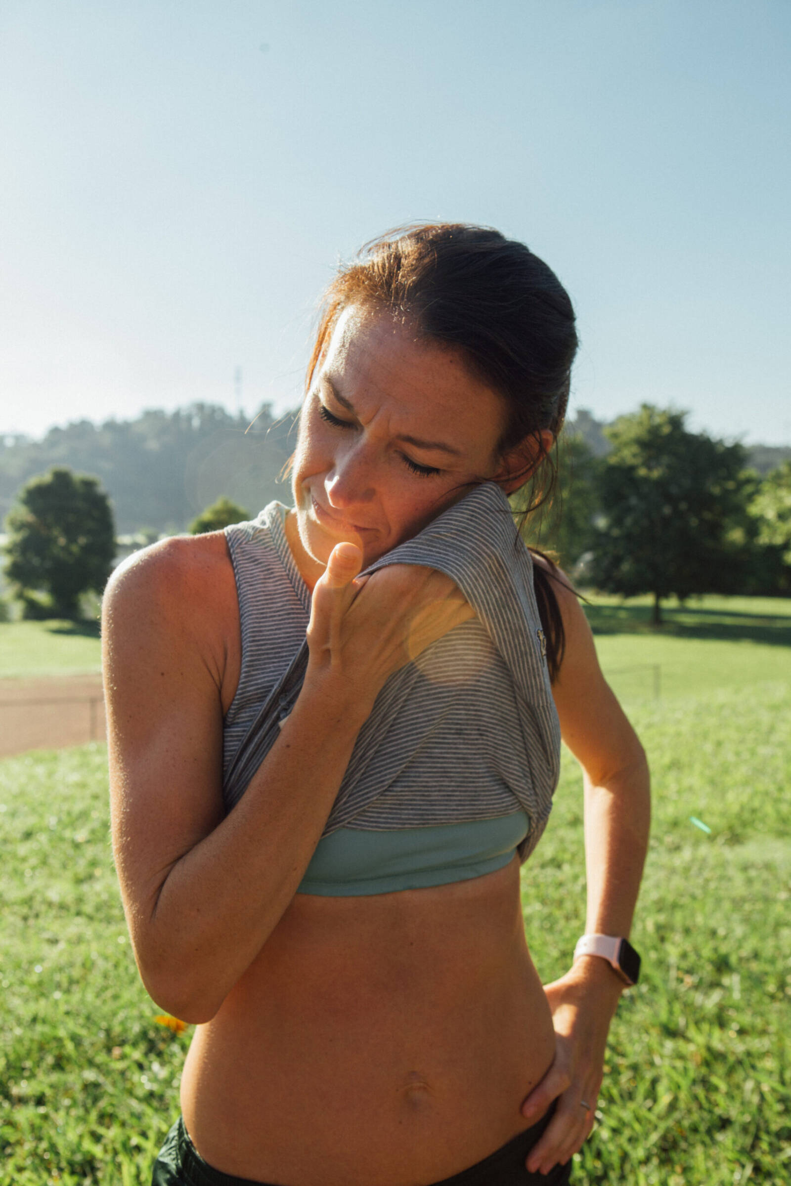 woman wiping sweat off her face