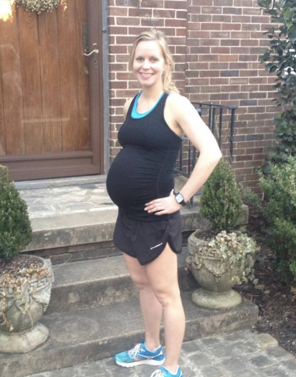 Pregnant woman in black with running shoes on.