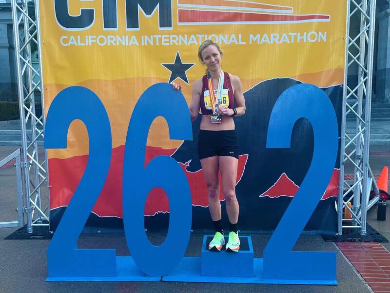 Whitney with finisher medal at CIM Marathon