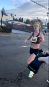 Whitney getting water during a race