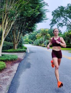 Whitney Heins running in red Tracksmith