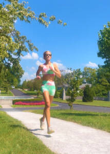 Whitney Heins running in tie-dyed outfit