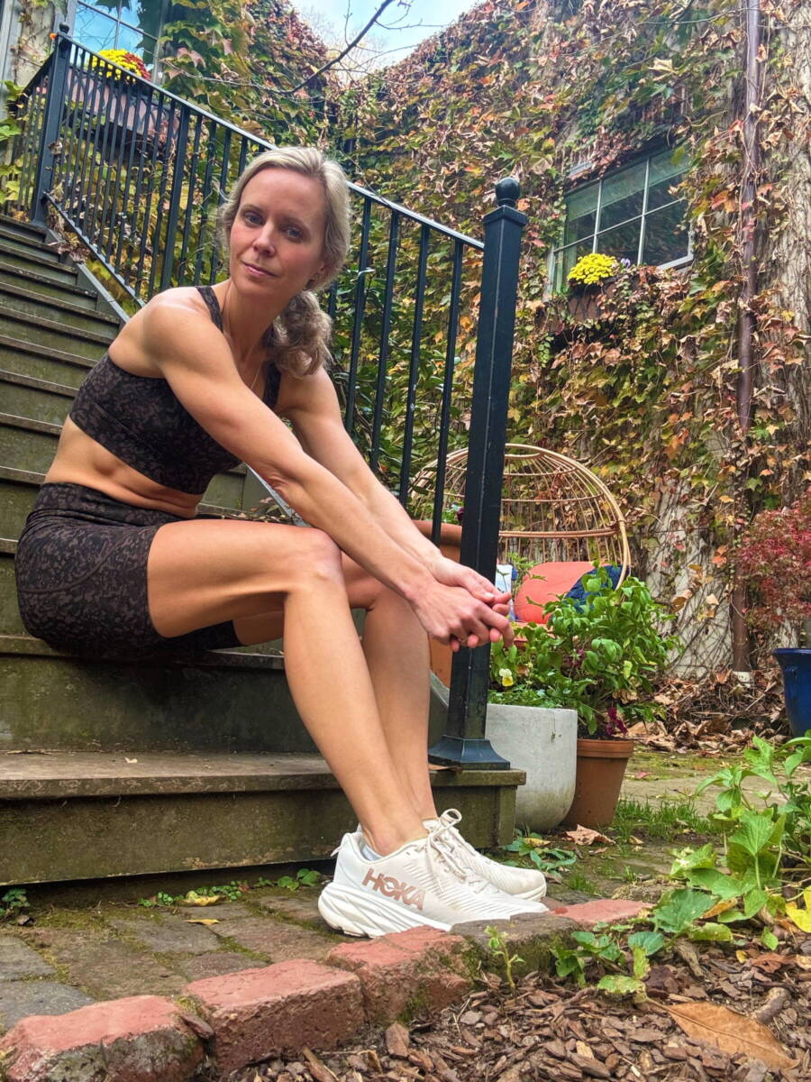 Whitney looking sad sitting on steps with a running injury