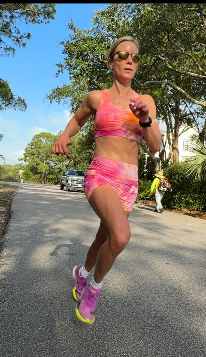 whitney running in orange outfit