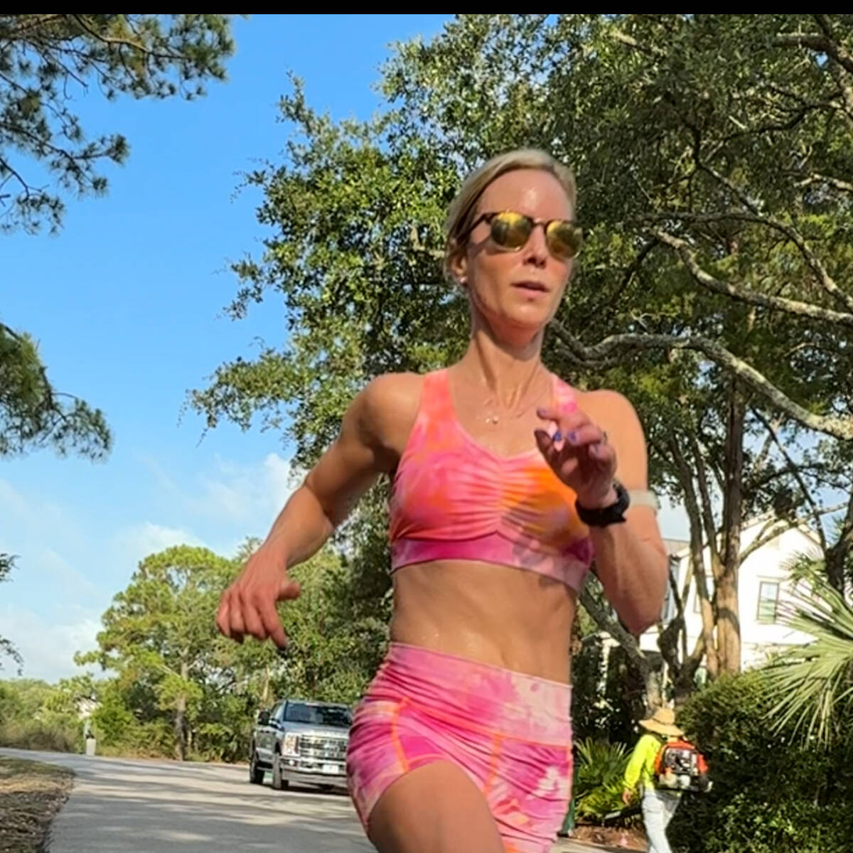 whitney running in orange outfit